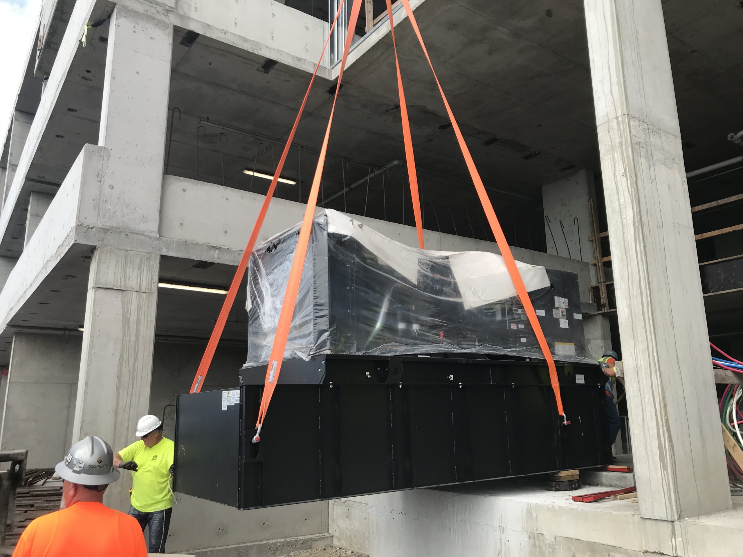 Commercial Generator Suspended in Air by Crane