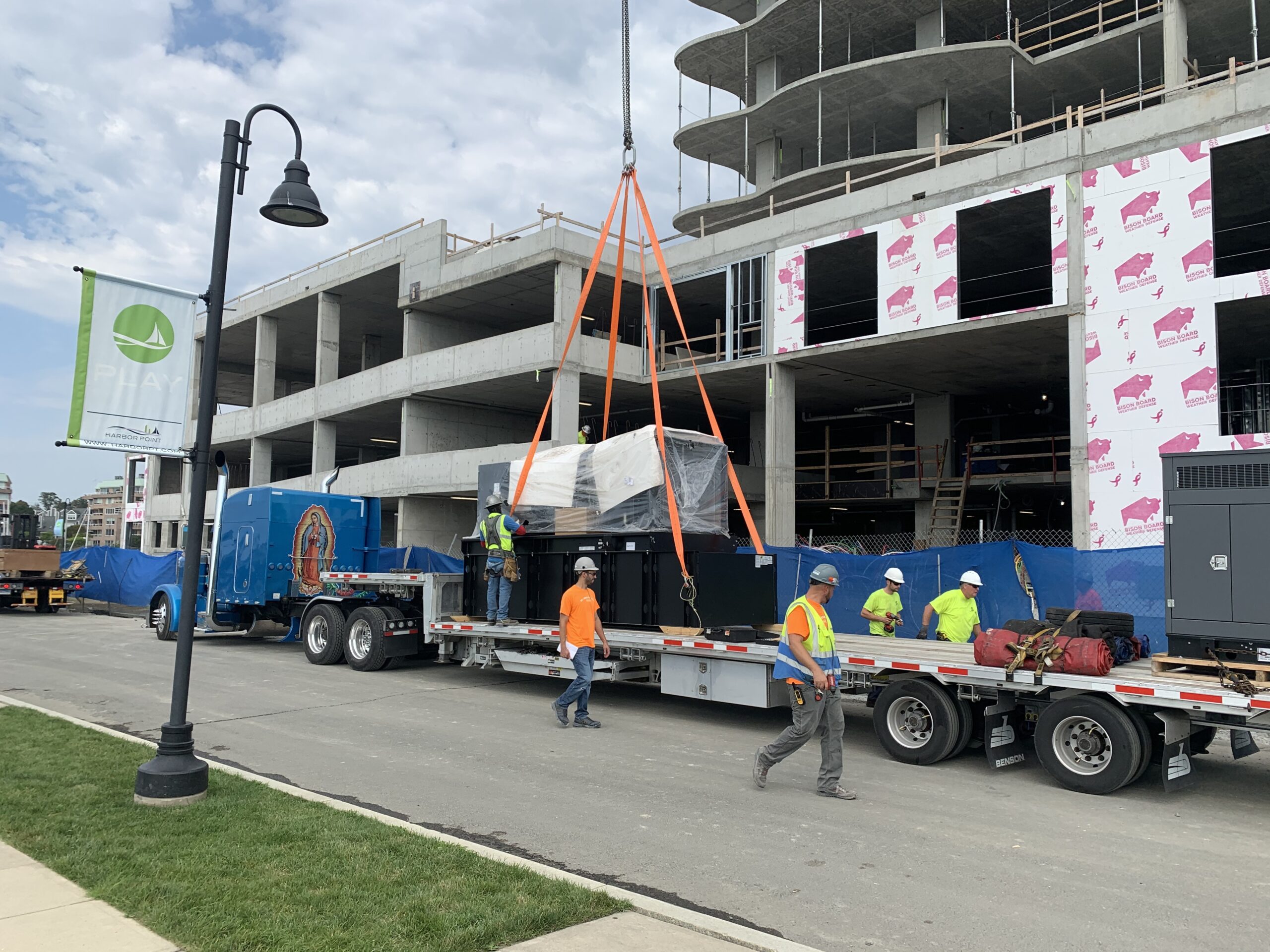 Commercial Generator being lifted off flatbed